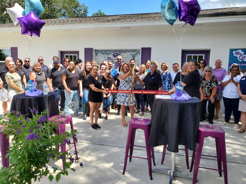 Lisa posed to cut the ribbon at Mrs. Grout's new location grand opening.