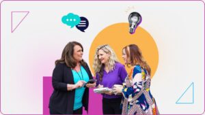 Three women talking, holding notebooks and phones, symbolize collaboration in referral-based marketing